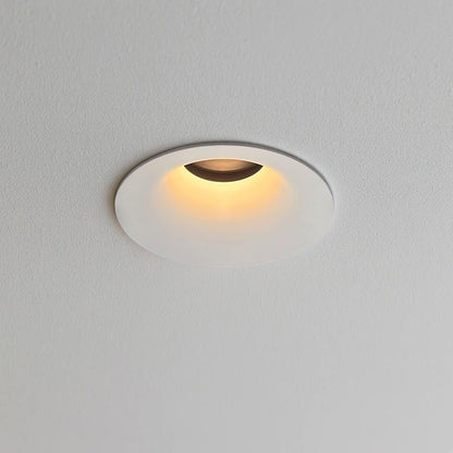 Warm white recessed ceiling downlight with a compact round profile and adjustable light direction
