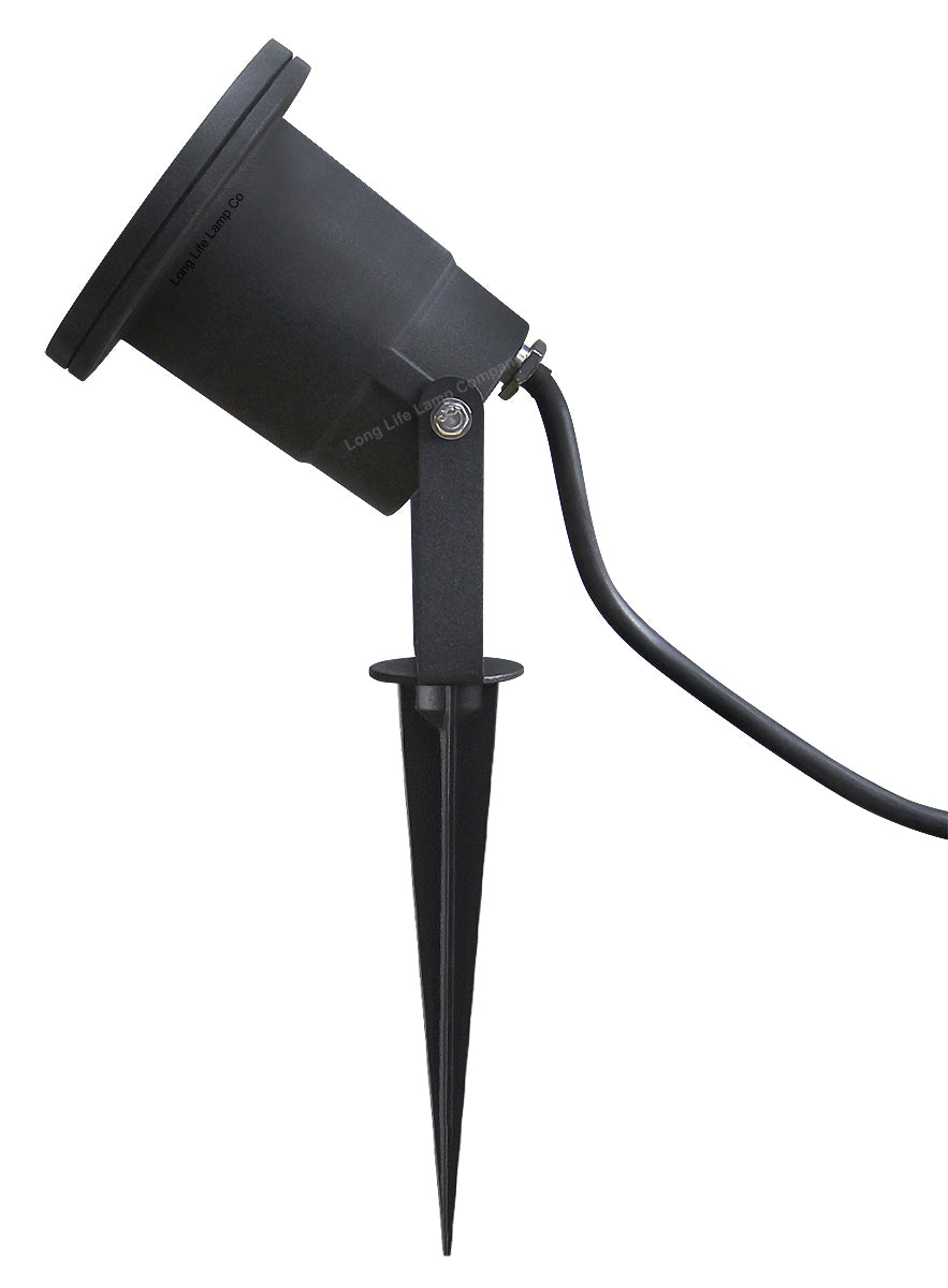 Four outdoor garden spotlights mounted with ground spikes beside a garden path