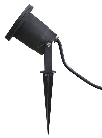 Four outdoor garden spotlights mounted with ground spikes beside a garden path