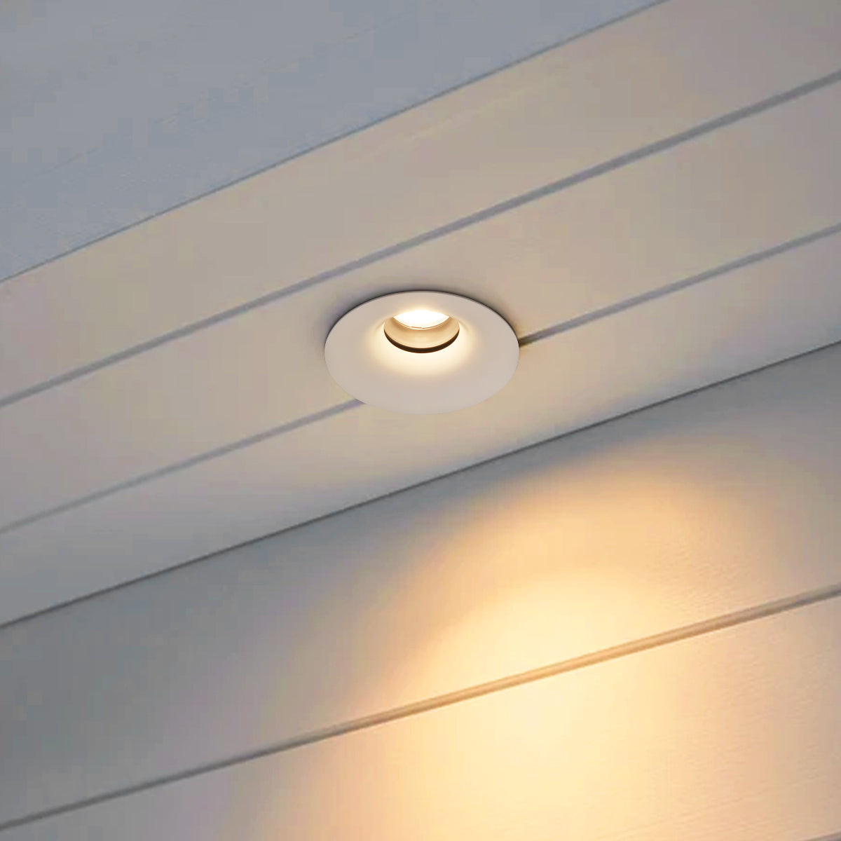 Adjustable warm white LED ceiling downlight with a clean round trim and recessed light source