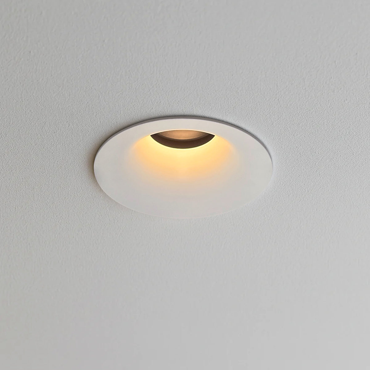 Warm white recessed ceiling downlight with a compact round profile and adjustable light direction