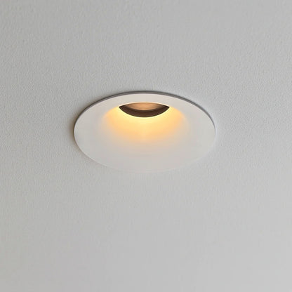 Warm white recessed ceiling downlight with a compact round profile and adjustable light direction