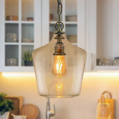 Traditional antique brass hanging ceiling light with a transparent glass shade and single-lamp design
